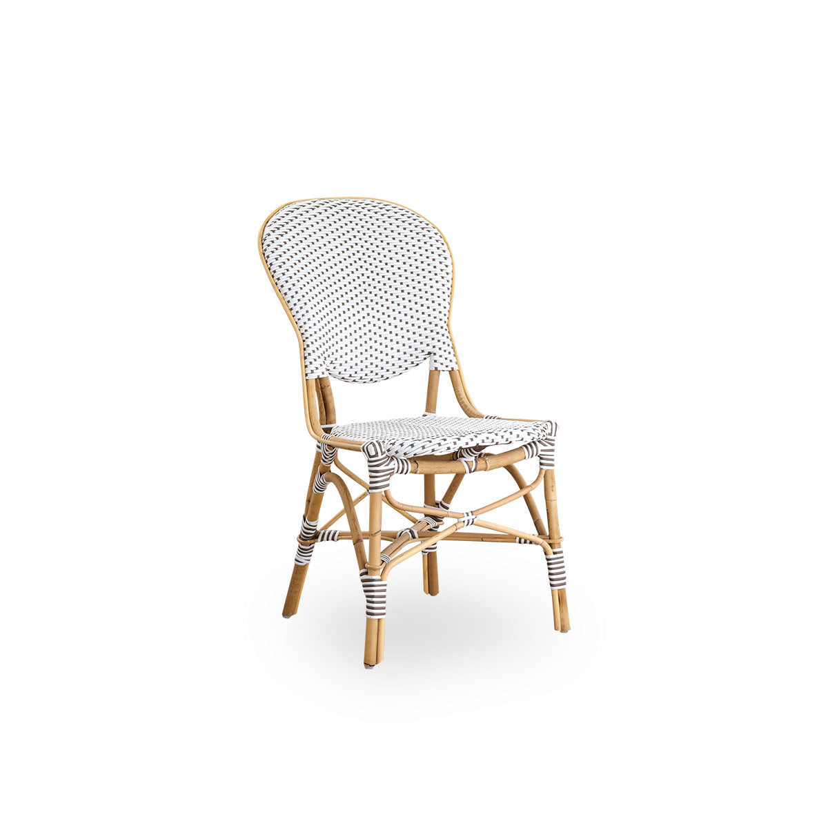 Side view of Isabell dining chair. Rattan frame with seat and backrest made in white ArtFibre with brown dots. Inspired by 1950s bistro design.
