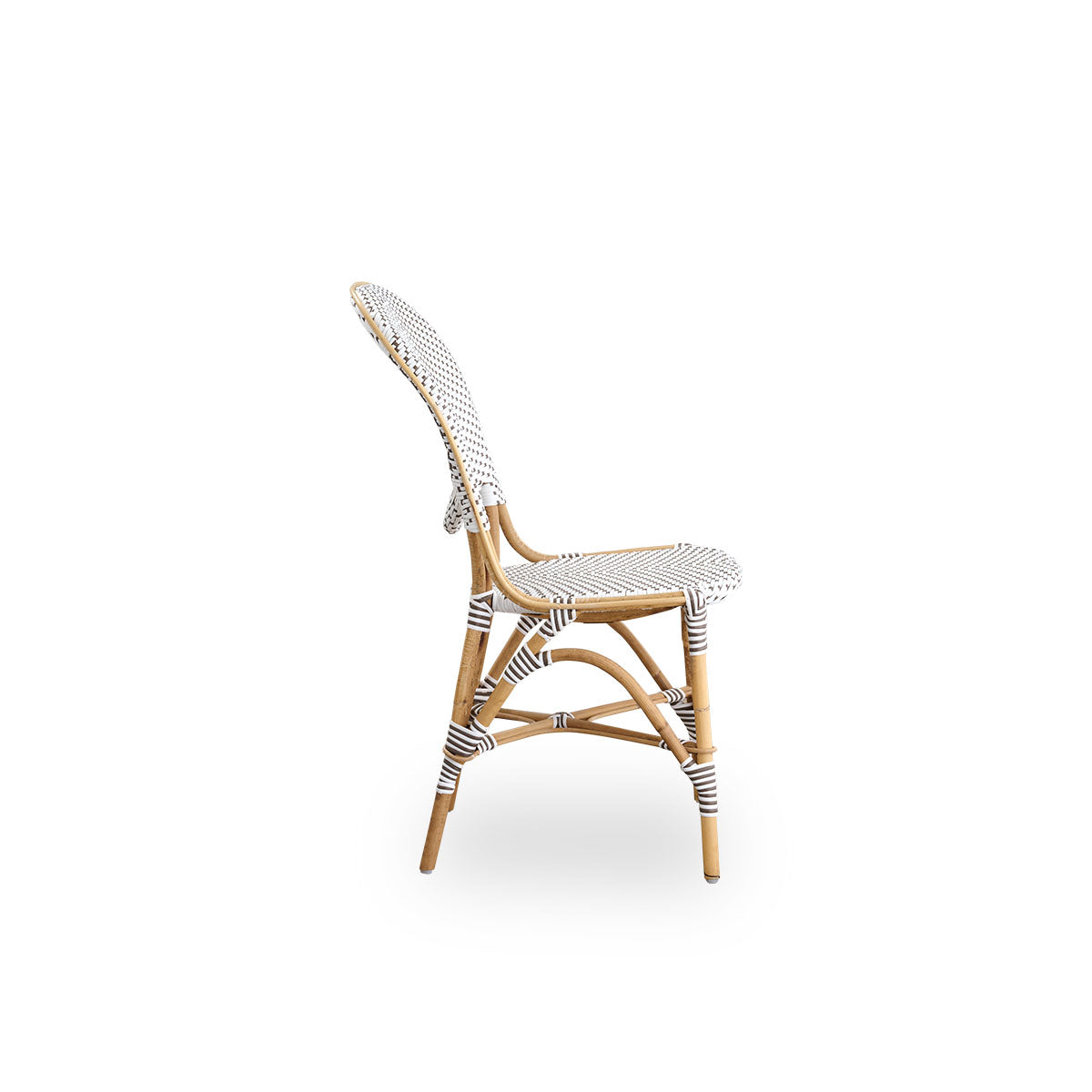 Plain side view of Isabell dining chair. Rattan frame with seat and backrest made in white ArtFibre with brown dots. Inspired by 1950s bistro design.