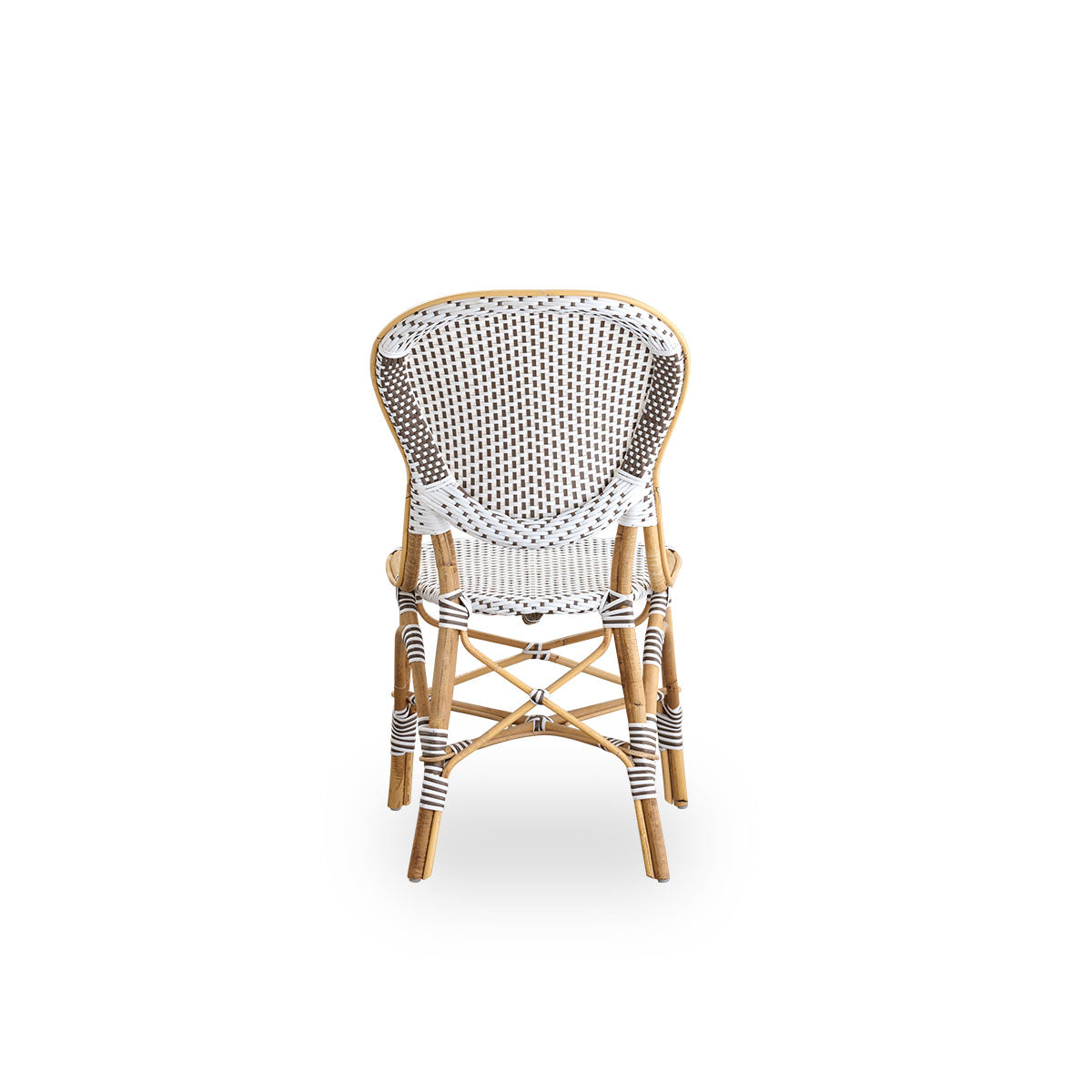 Plain back view of Isabell dining chair. Rattan frame with seat and backrest made in white ArtFibre with brown dots. Inspired by 1950s bistro design.