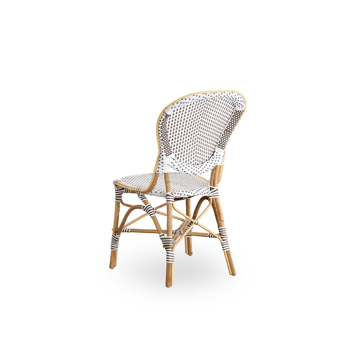 Back side view of the Isabell dining chair.
Rattan frame with seat and backrest made in white ArtFibre with brown dots. Inspired by 1950s bistro design.