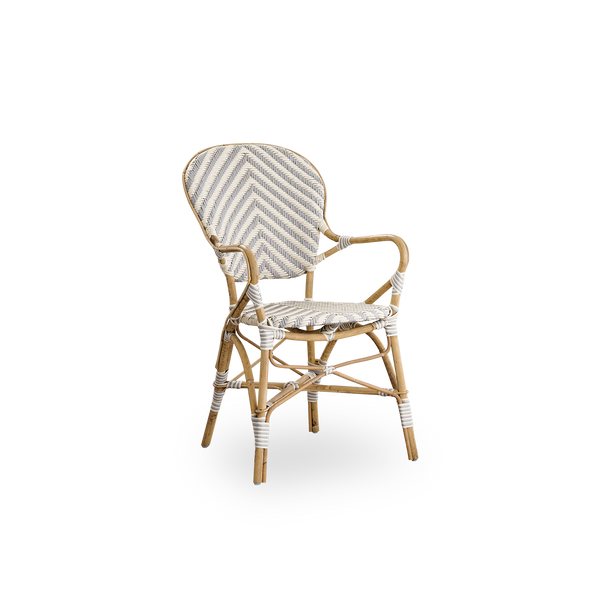 Side view of Isabell dining chair with armrest. Rattan frame with seat and backrest made in ArtFibre in ivory and grey herringbone pattern. Inspired by 1950s bistro design.