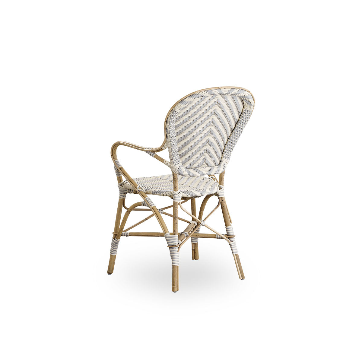 Back side view of the Isabell dining chair with armrests.
Rattan frame with seat and backrest made in ArtFibre in an ivory and grey herringbone pattern. Inspired by 1950s bistro design.