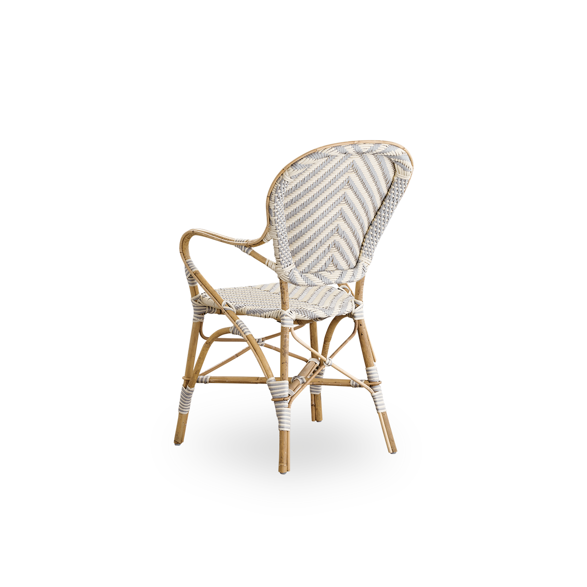 Back side view of the Isabell dining chair with armrests.
Rattan frame with seat and backrest made in ArtFibre in an ivory and grey herringbone pattern. Inspired by 1950s bistro design.