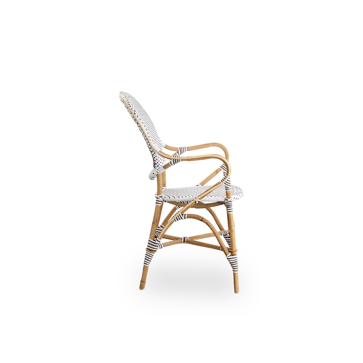 Plain side view of Isabell dining chair with armrest. Rattan frame with seat and backrest made in white ArtFibre with brown dots. Inspired by 1950s bistro design.