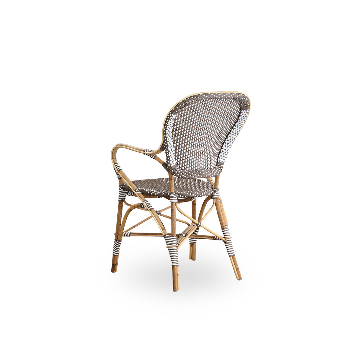 Back side view of the Isabell dining chair with armrests.
Rattan frame with seat and backrest made in brown ArtFibre with white dots. Inspired by 1950s bistro design.