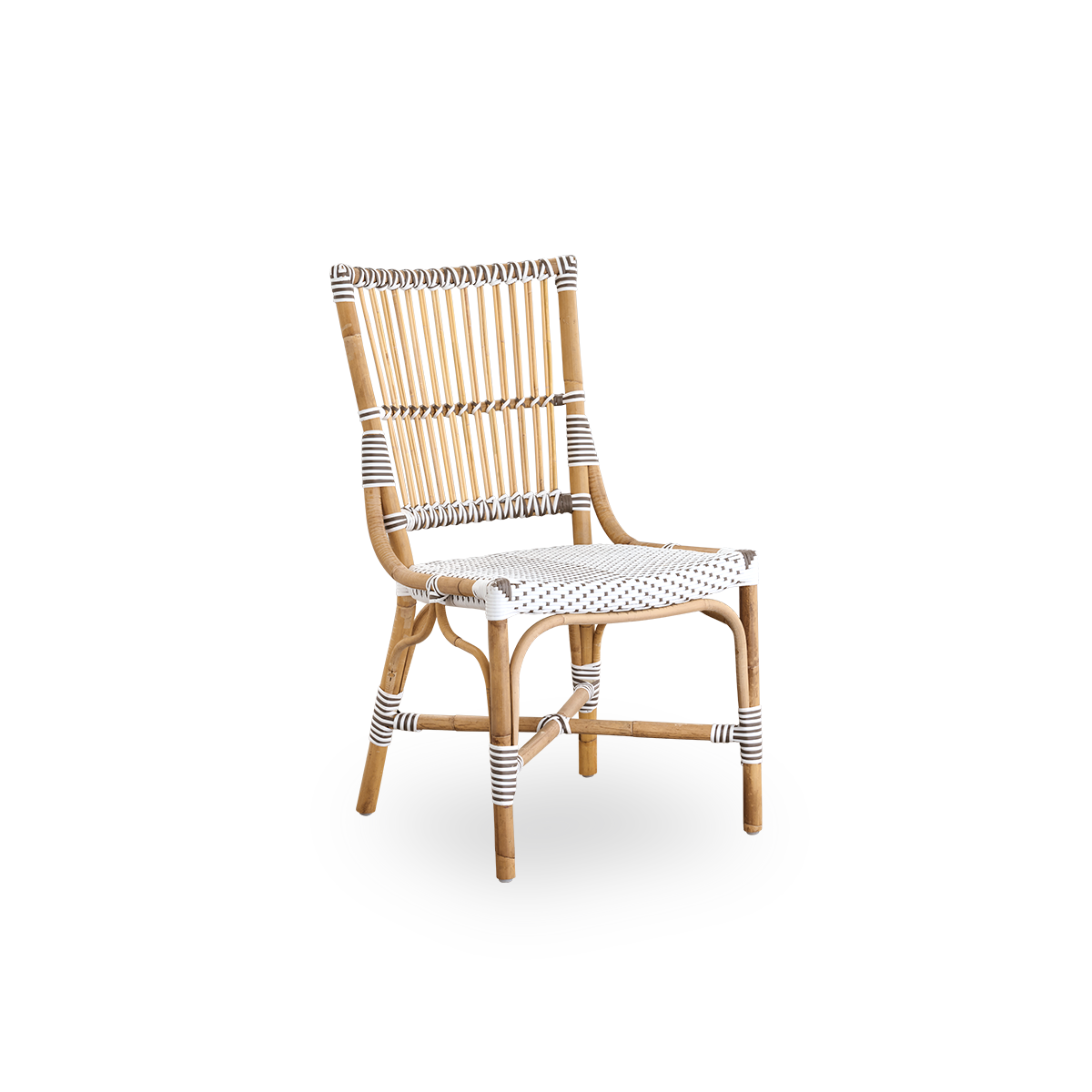 Side view of Monique dining chair. Rattan frame with seat woven with ArtFibre in white with brown dots. Inspired by 1950s bistro design.