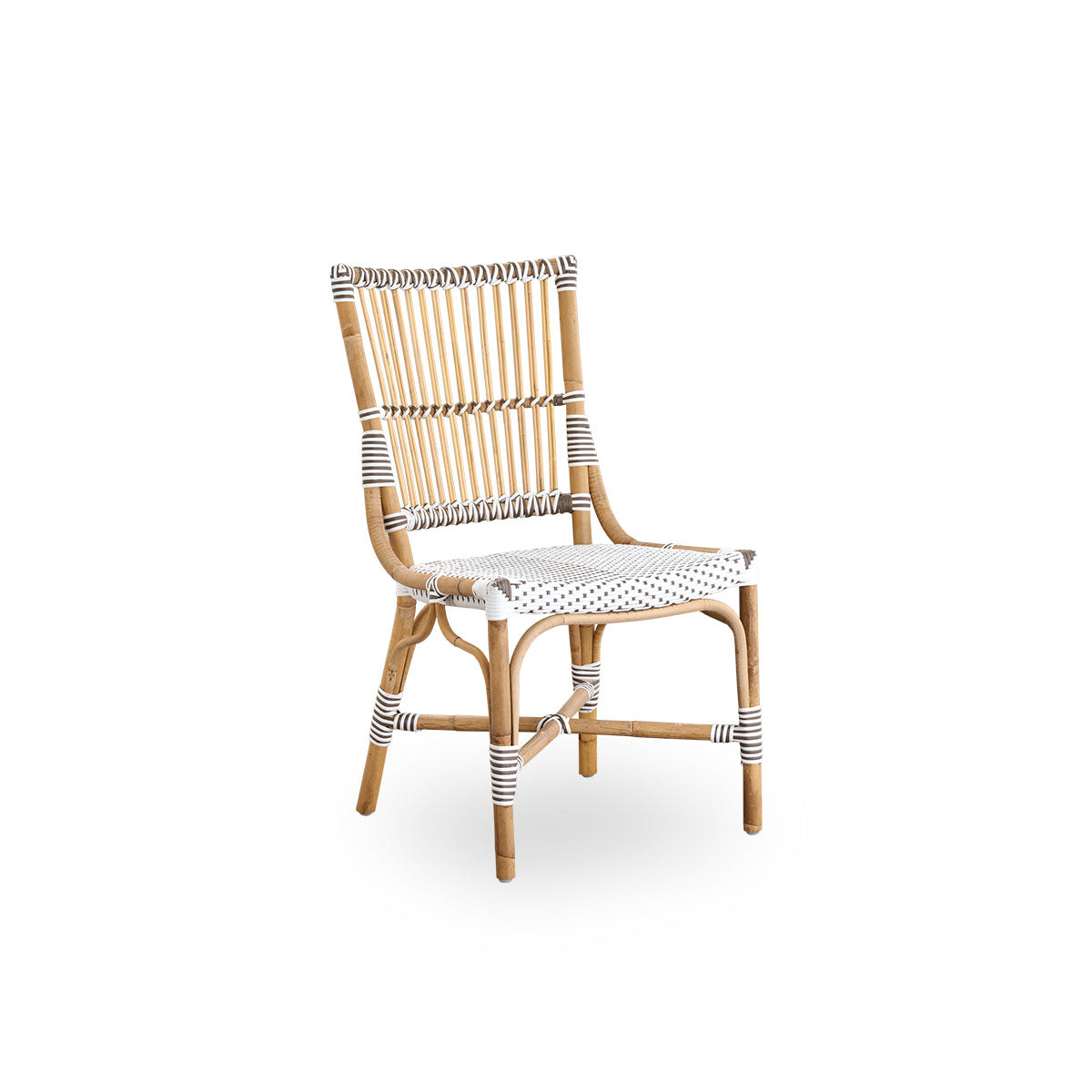 Side view of Monique dining chair. Rattan frame with seat woven with ArtFibre in white with brown dots. Inspired by 1950s bistro design.