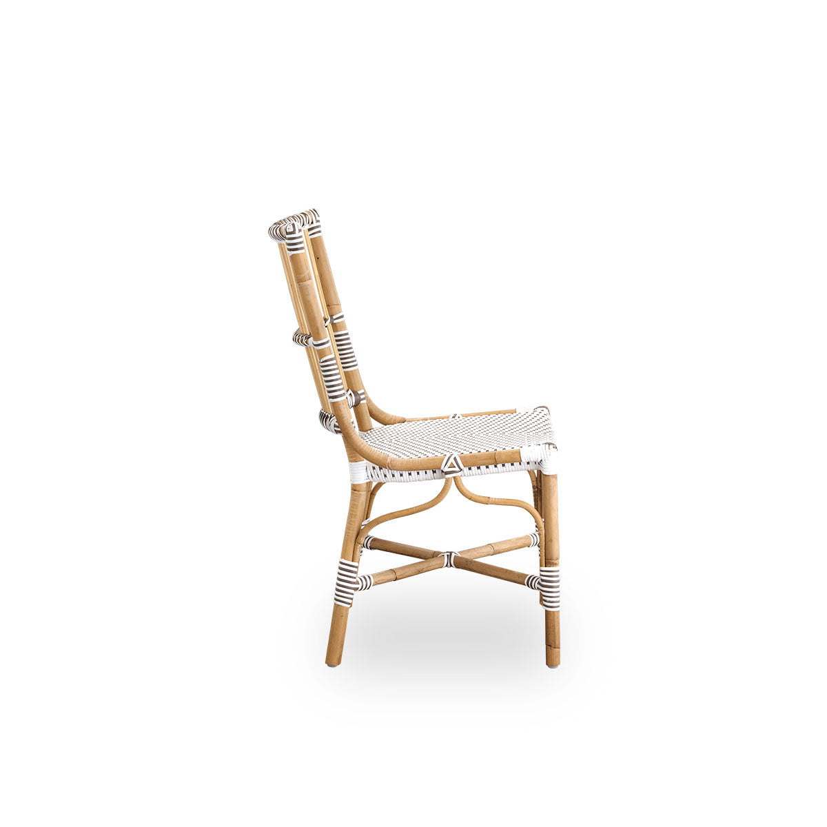 Plain side view of Monique dining chair. Rattan frame with seat woven with ArtFibre in white with brown dots. Inspired by 1950s bistro design.