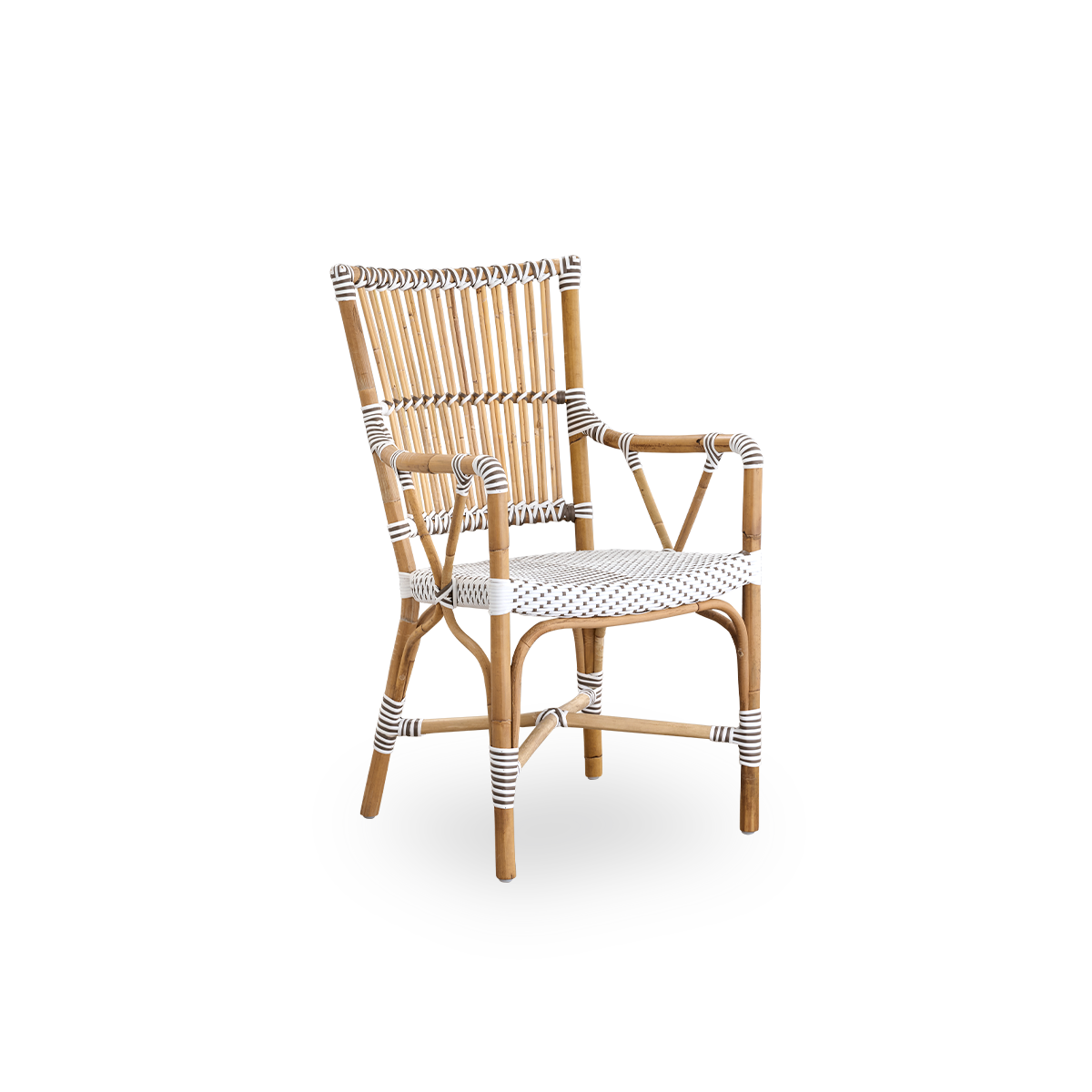 Side view of Monique dining armchair. Rattan frame with seat woven with ArtFibre in white with brown dots. Inspired by 1950s bistro design.