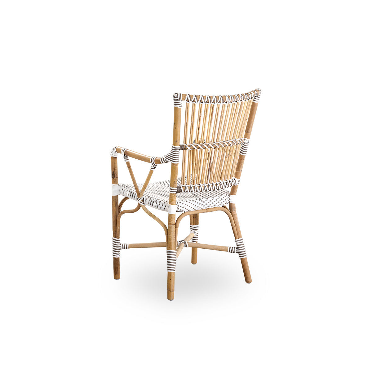 Back side view of the Monique dining armchair.
Rattan frame with seat woven with ArtFibre in white with brown dots. Inspired by 1950s bistro design.