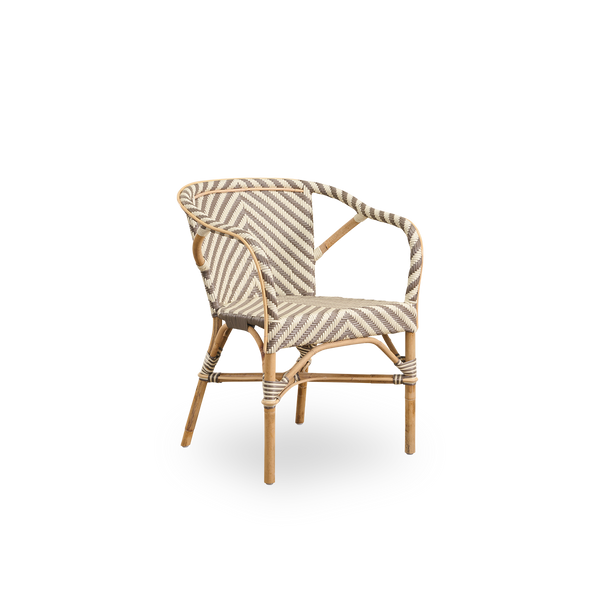 Side view of Madeleine dining armchair. Rattan frame with seat and backrest woven with ArtFibre in ivory and brown herringbone pattern. Inspired by 1950s bistro design.