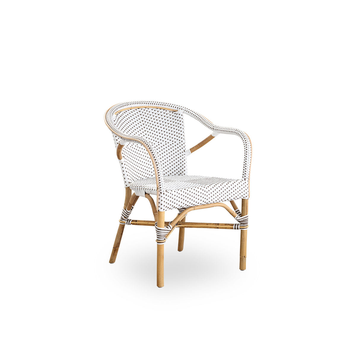 Side view of Madeleine dining armchair. Rattan frame with seat and backrest woven with ArtFibre in white with brown dots. Inspired by 1950s bistro design.