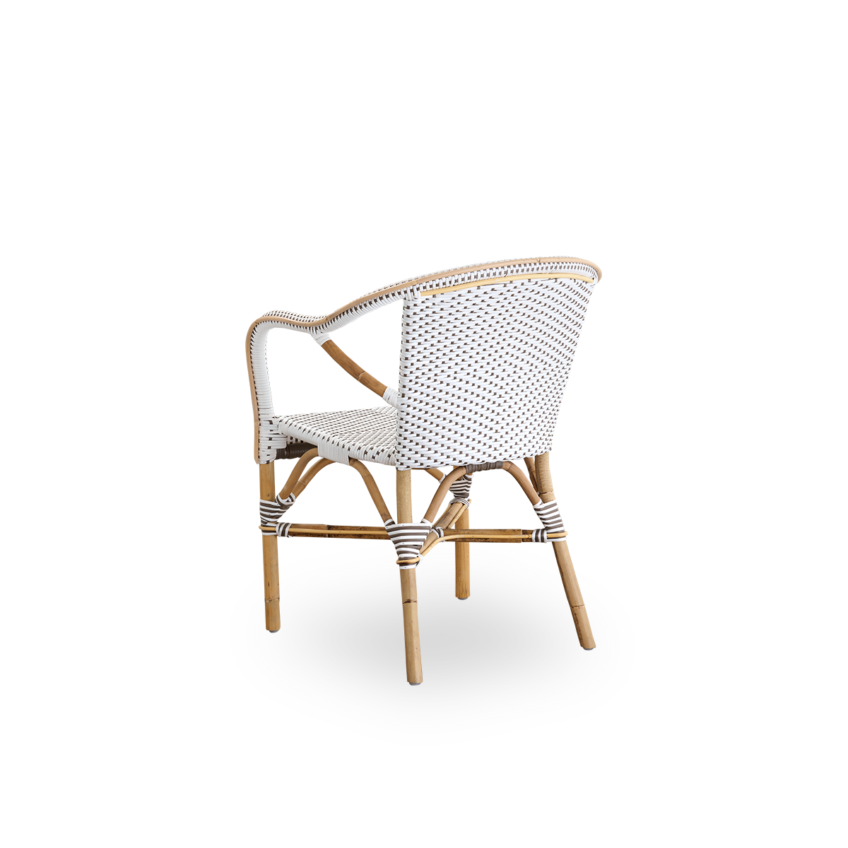 Back side view of the Madeleine dining armchair.
Rattan frame with seat and backrest woven with ArtFibre in white with brown dots. Inspired by 1950s bistro design.