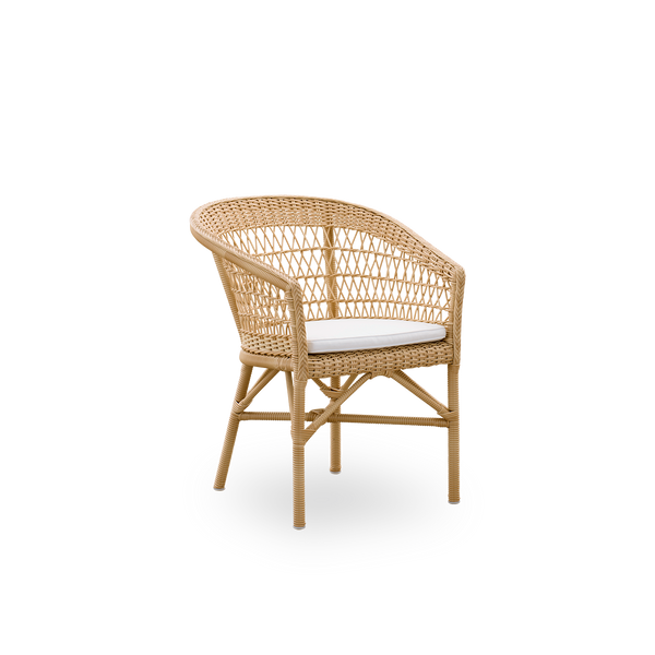 Side view of Emma outdoor dining chair in Natural color, inspired by British colonial style. Round backrest turns into armrest. Aluminum frame fully woven with ArtFibre.