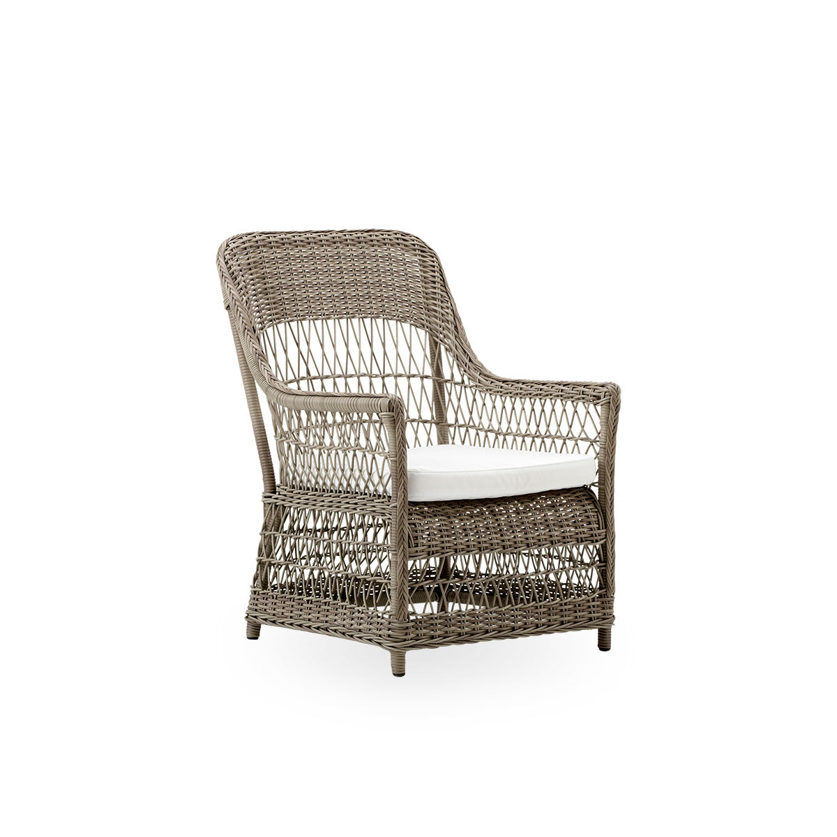 Side view of the Dawn outdoor lounge chair in antique grey color, inspired by British colonial style. Romantic lounge chair with armrest and a high backrest. Fully woven ArtFibre on hand-bent aluminum frame.