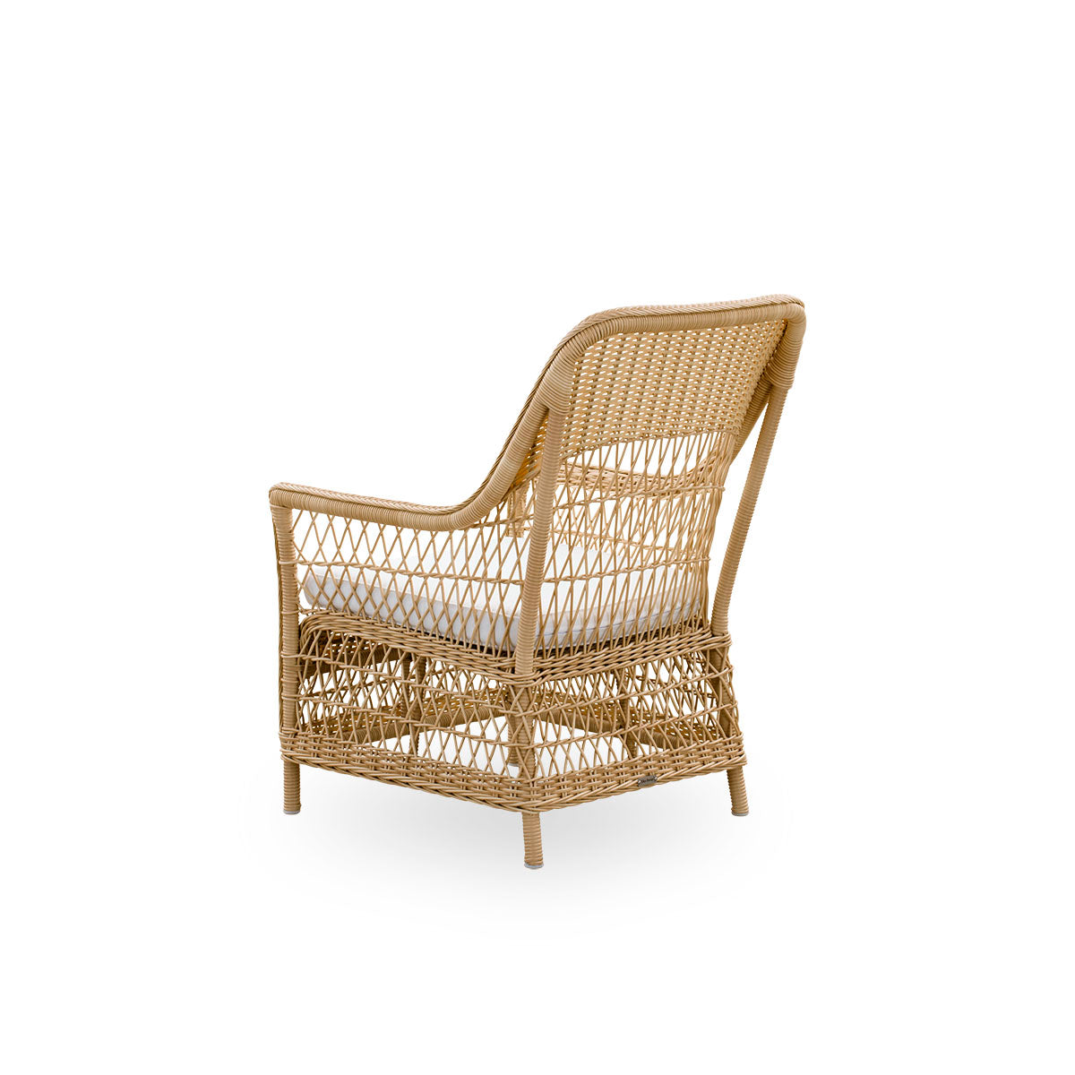 Plain back view of the Dawn outdoor lounge chair in natural color, inspired by British colonial style. Romantic lounge chair with armrest and a high backrest. Fully woven ArtFibre on hand-bent aluminum frame.