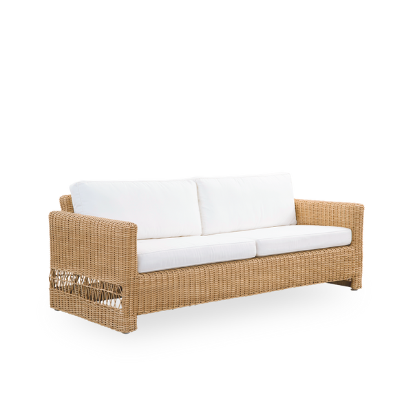 Side view of Carrie outdoor sofa in the color Natural. Squared robust 3-seater sofa made with aluminium frame fully woven with ArtFibre.