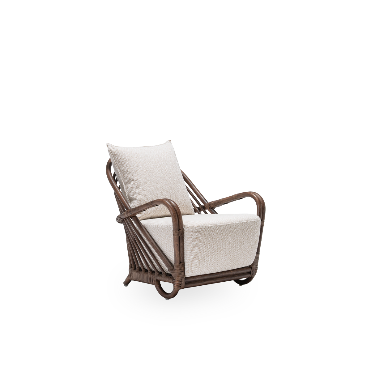 Side view of the Charlottenborg lounge chair with seat and back cushions, in brown rattan. Designed by Arne Jacobsen in 1936 and part of Sika-Design's ICONS collection of reissued designer furniture. Handcrafted from high-quality Indonesian rattan.