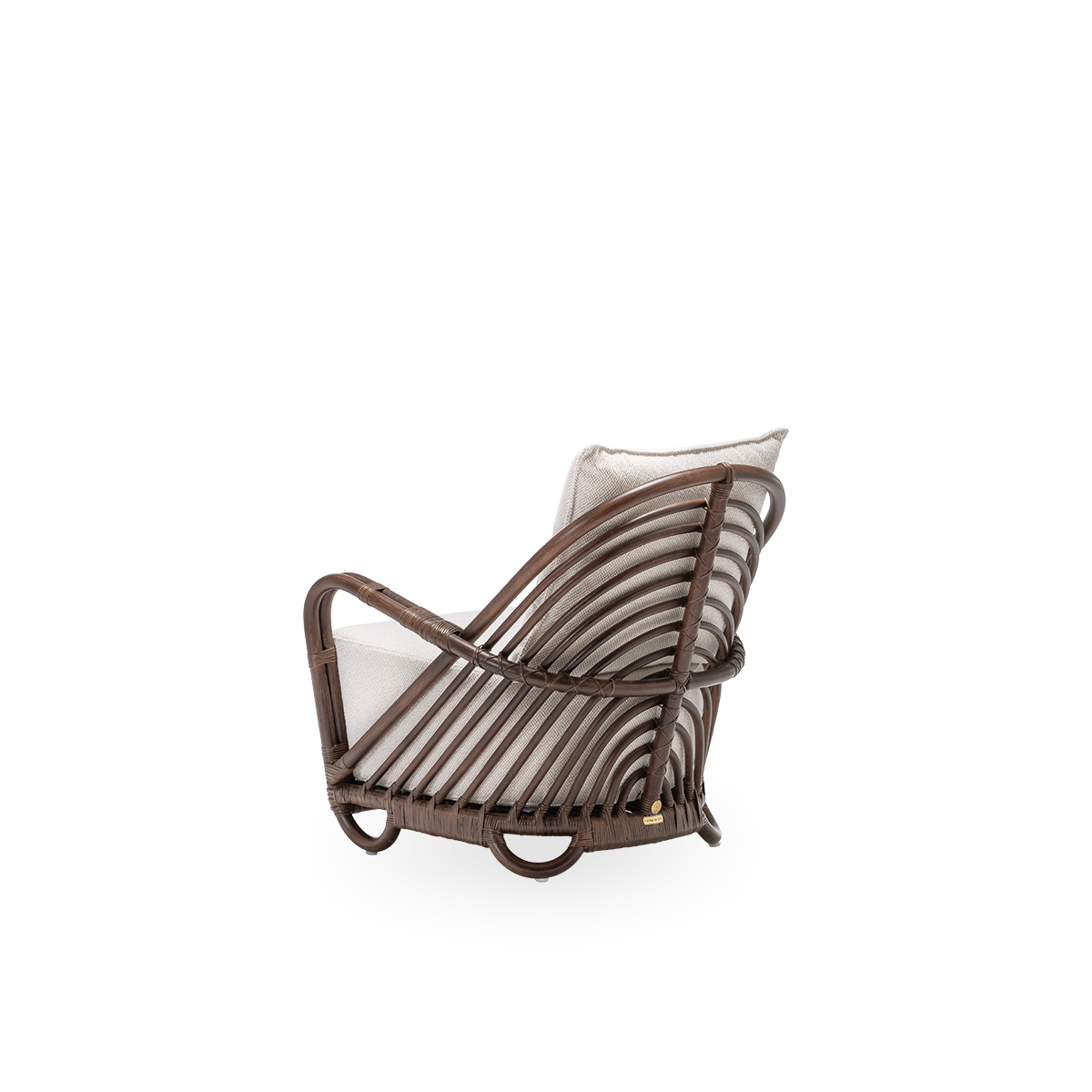 Back side view of the Charlottenborg lounge chair with seat and back cushions, in brown rattan. Designed by Arne Jacobsen in 1936 and part of Sika-Design's ICONS collection of reissued designer furniture. Handcrafted from high-quality Indonesian rattan.