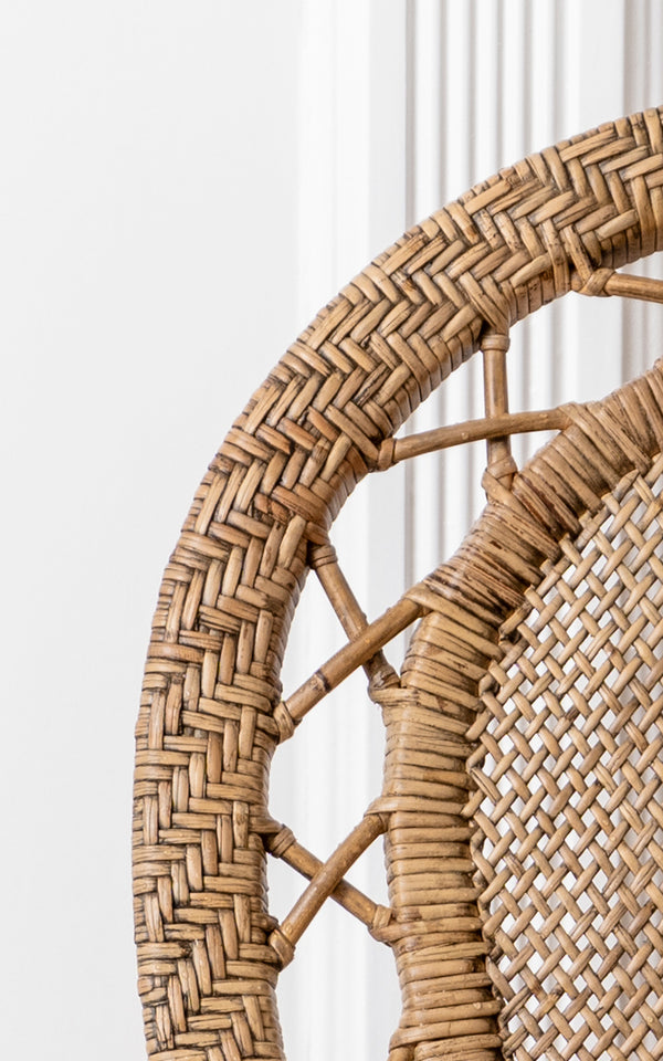 This is a close-up image of Romantica Dining Chair in antique rattan. The herringbone weave border and decorative crossed rattan frame are shown.
