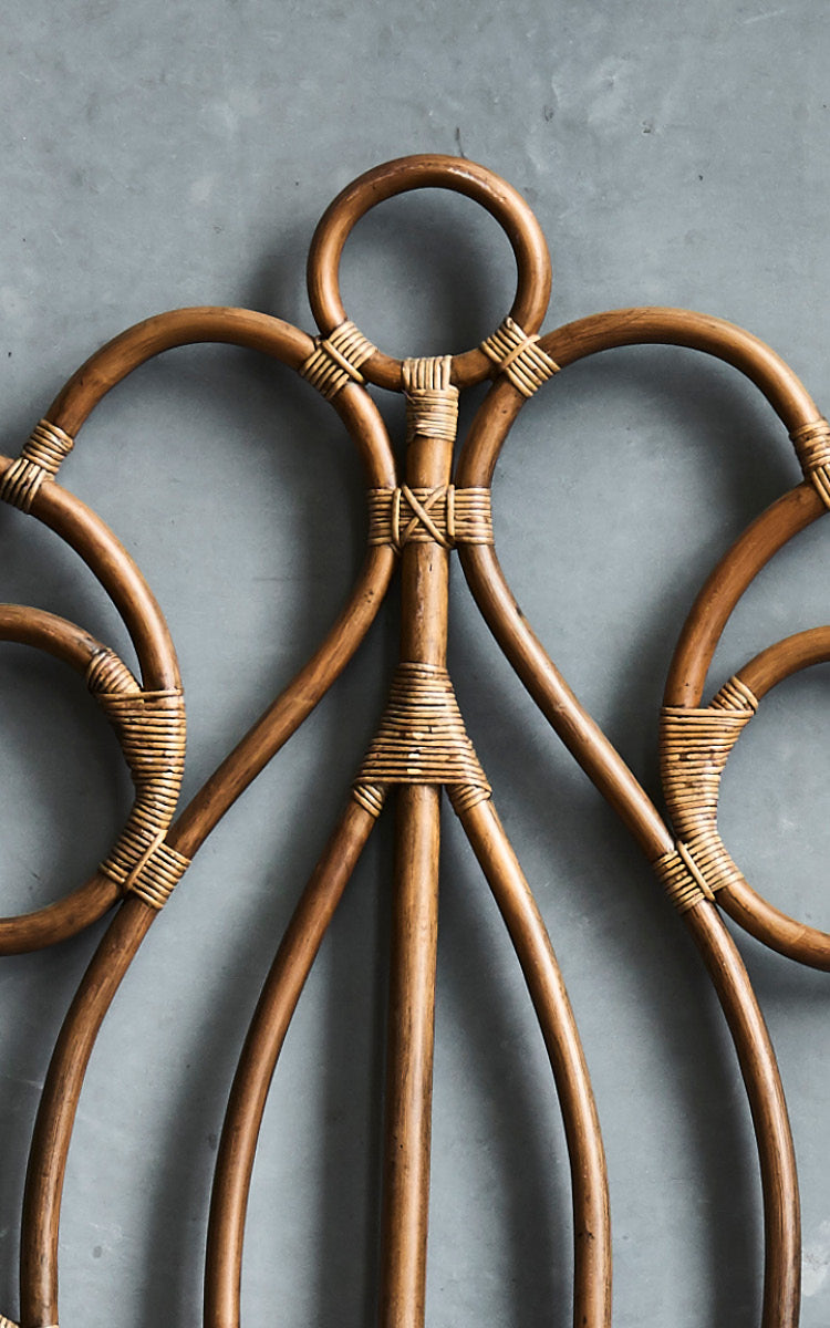 This is a close-up image of Natalia Headboard in antique rattan.