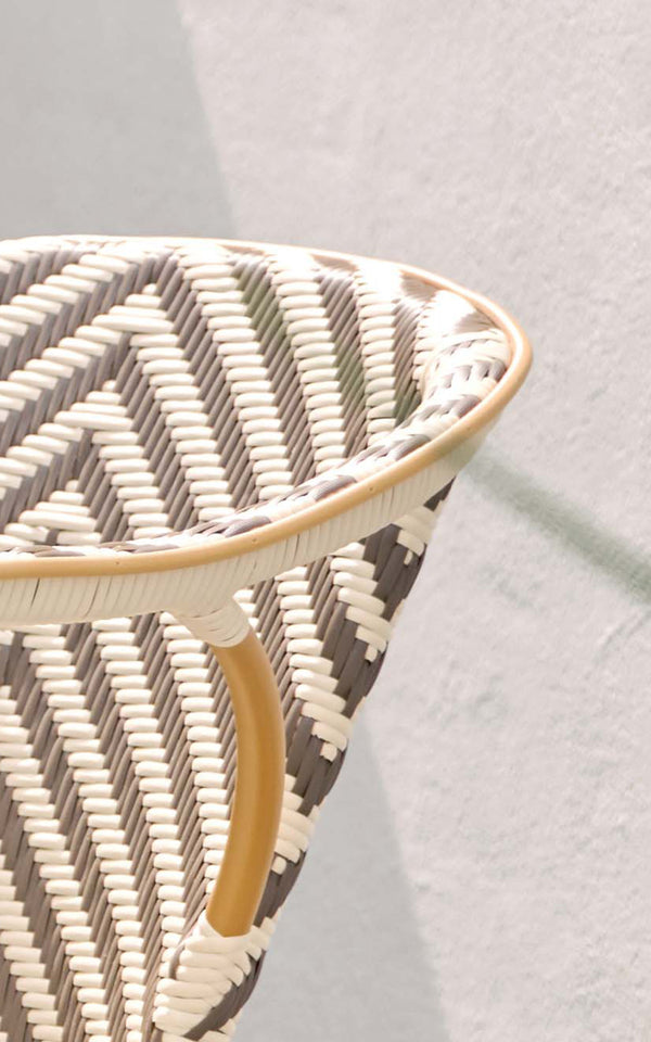 This is a close-up image of Madeleine Exterior Dining Chair in almond aluminum frame chevron cappuccino ivory ArtFibre. Chevron weave detail.