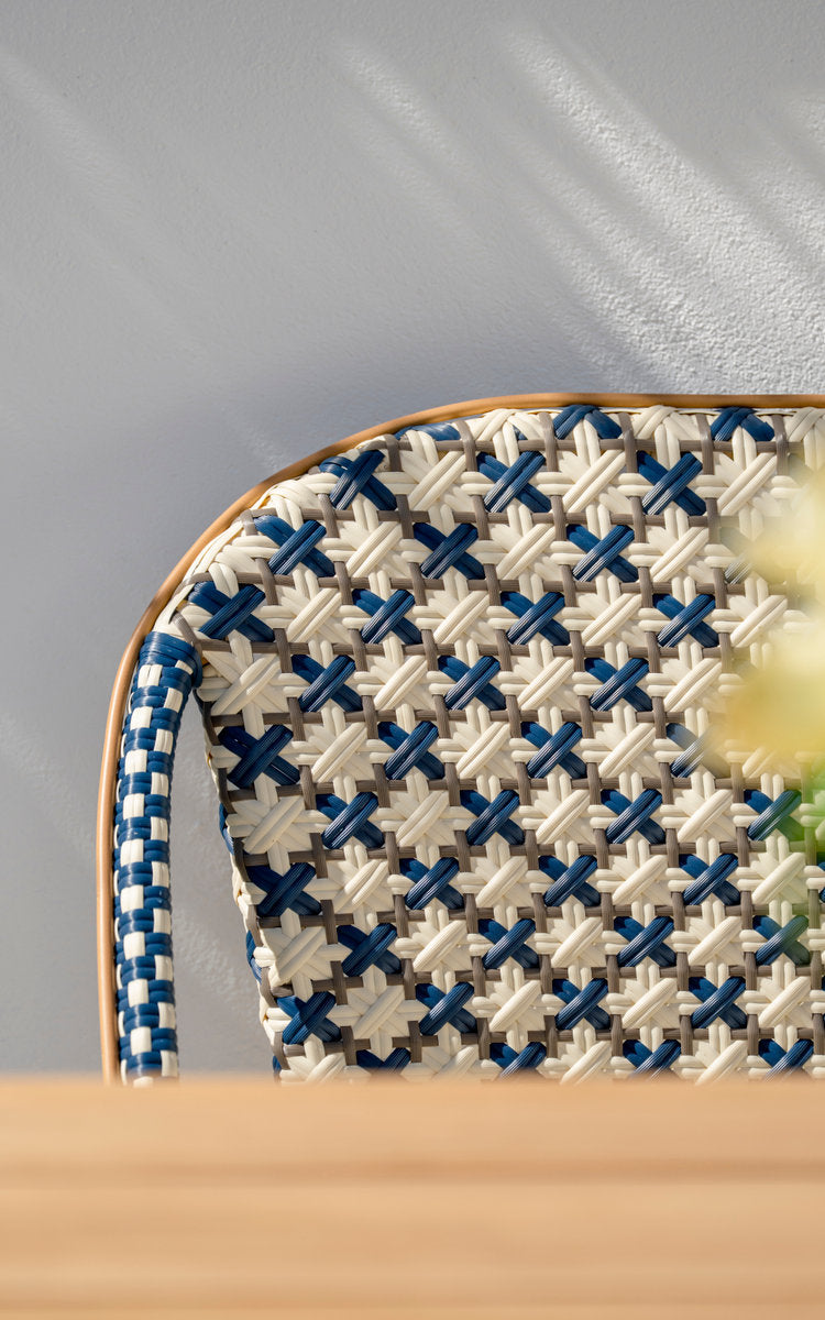 This is a close-up image of Sofie Exterior 3-Seater Bench in almond aluminium frame starweave ivory navy blue cappuccino artfibre. Woven backrest.