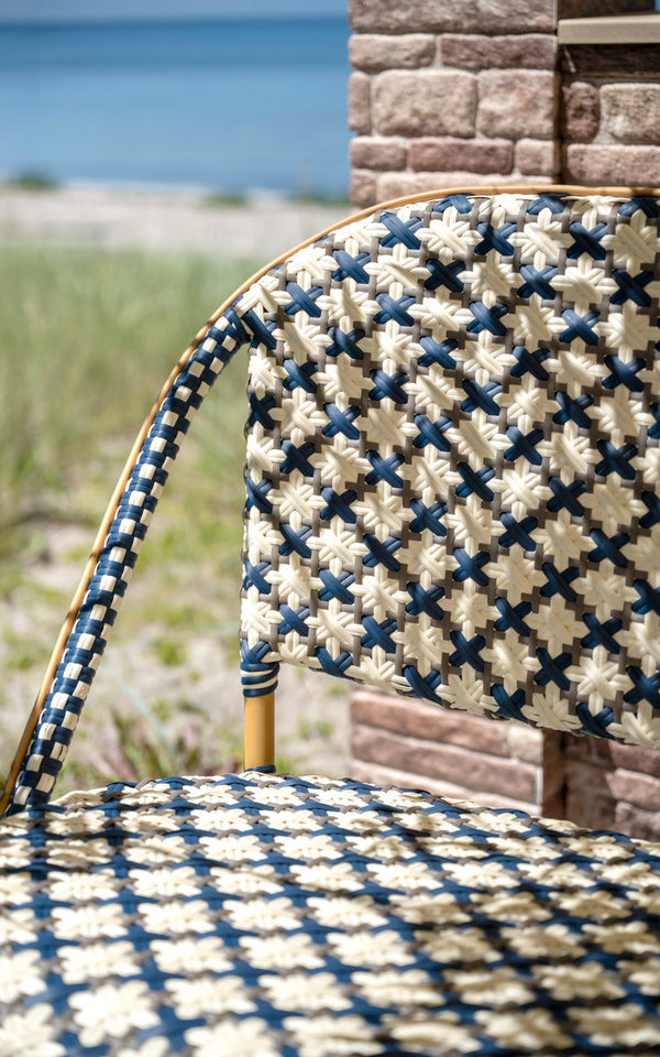 This is a close-up image of Sofie Exterior 8-Seater Bench in almond aluminium frame starweave ivory navy blue cappuccino artfibre. Weave detail.