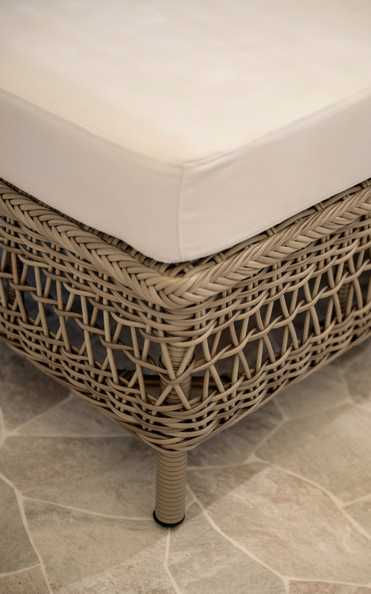 This is a close-up image of Mona Exterior Modular Sofa-Pouf Module in antique grey artfibre aluminium. Woven pouf edge with white cushion.