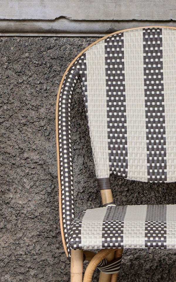 This is a close-up image of Sofie Dining Chair in striped cappuccino ivory artfibre skin on rattan frame.