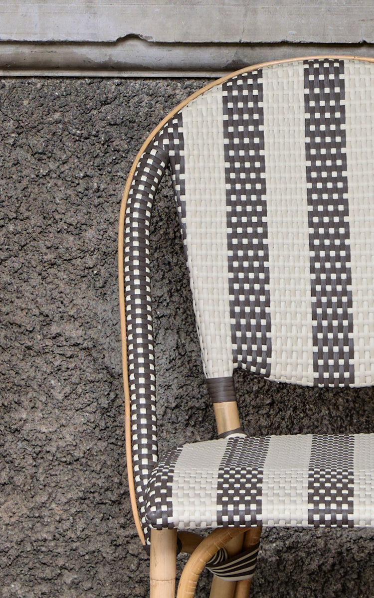 This is a close-up image of Sofie Dining Chair in striped cappuccino ivory artfibre skin on rattan frame.
