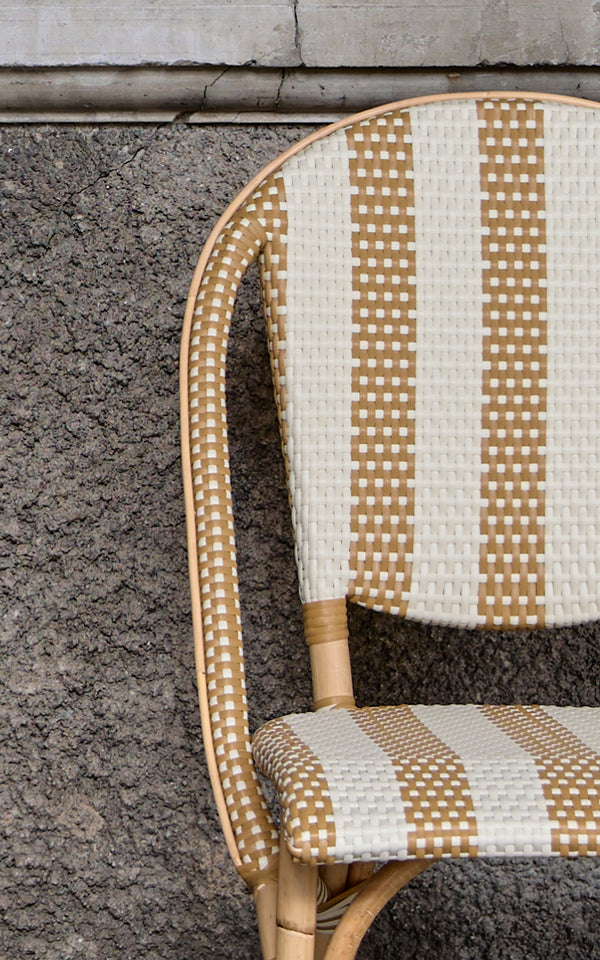This is a close-up image of Sofie Dining Chair in striped honey ivory artfibre skin on rattan frame.