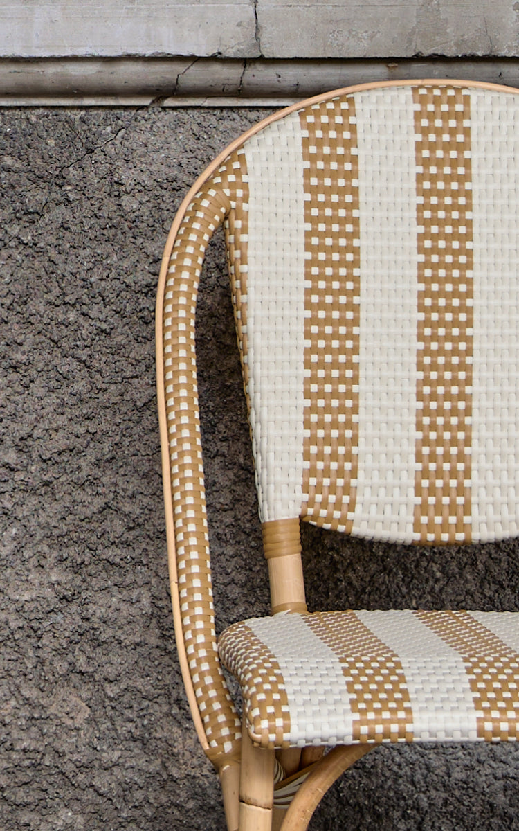 This is a close-up image of Sofie Dining Chair in striped honey ivory artfibre skin on rattan frame.