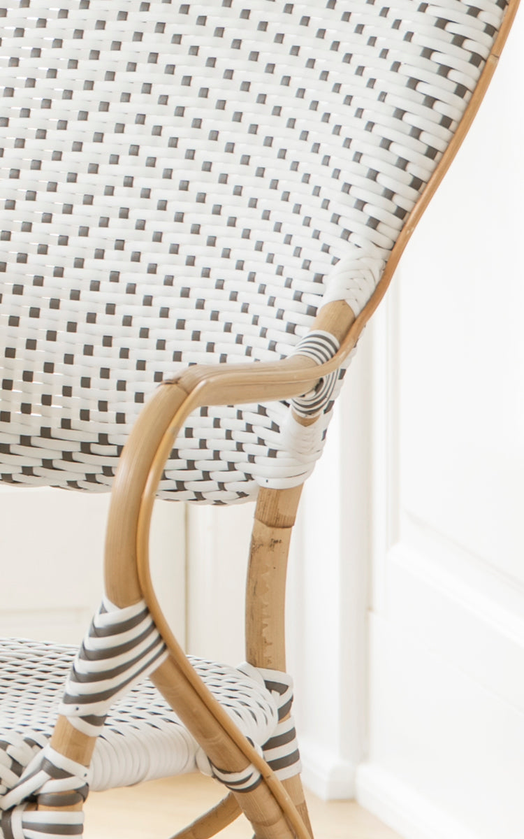 This is a close-up image of Isabell Dining Armchair in white w cappuccino dot ArtFibre Skin on Rattan frame.
