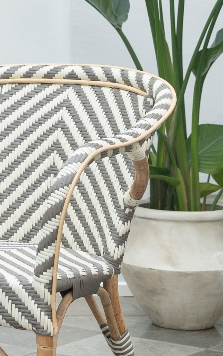 This is a close-up image of Madeleine Dining Chair in chevron cappuccino ivory ArtFibre skin on rattan frame. Bold chevron weave pattern.