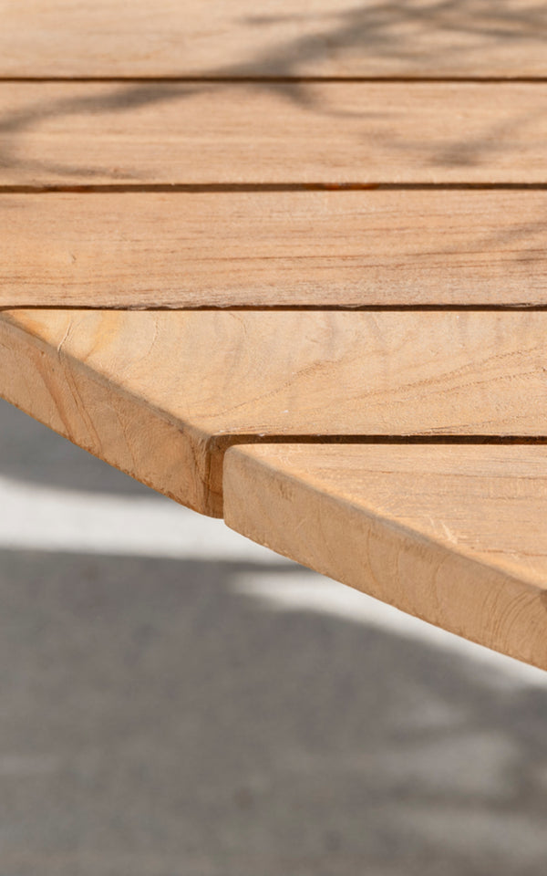 This is a close-up image of George Exterior Table Ø120 in outdoor Teak.