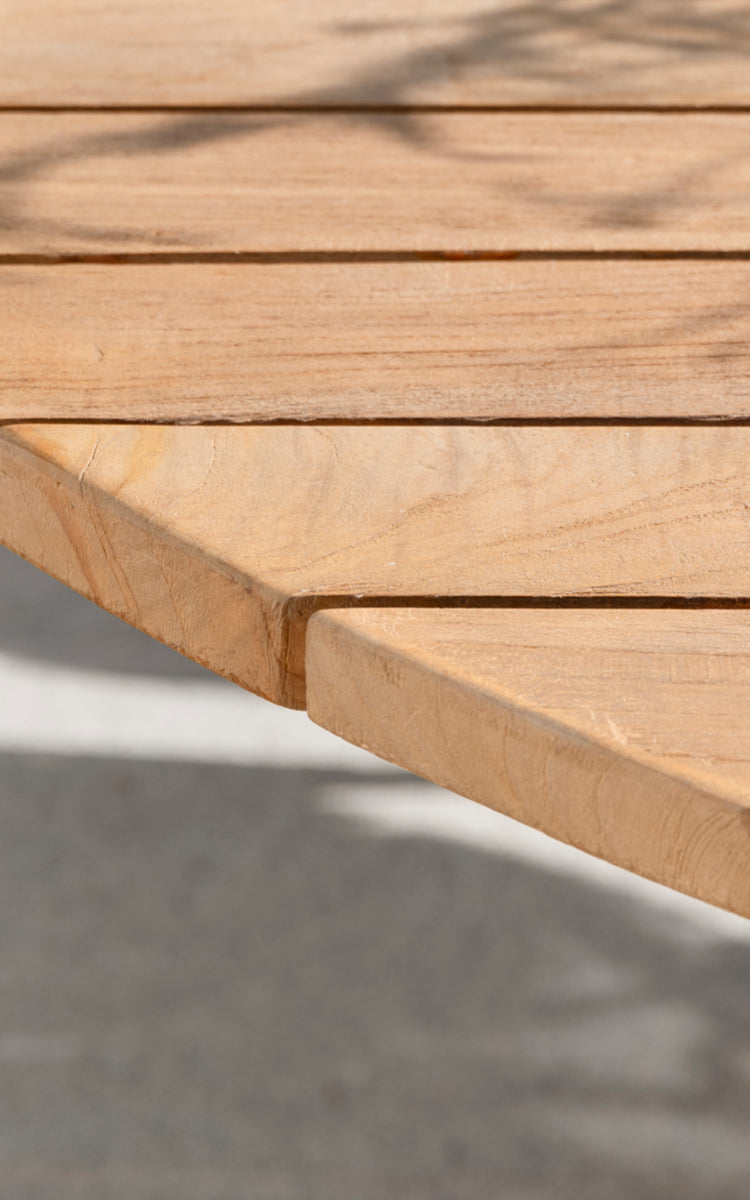 This is a close-up image of George Exterior Table Ø120 in outdoor Teak.