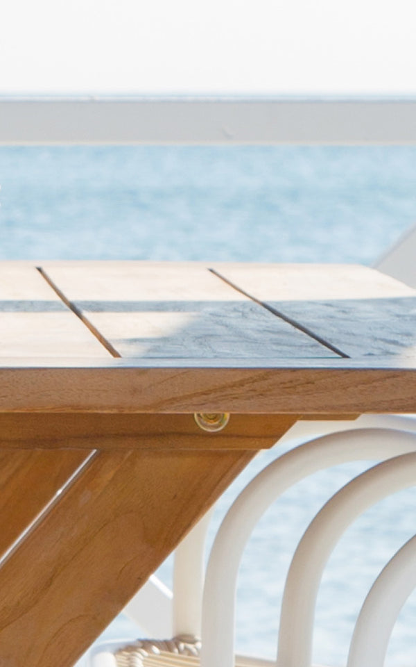 This is a close-up image of Colonial Table 160 in outdoor Teak.