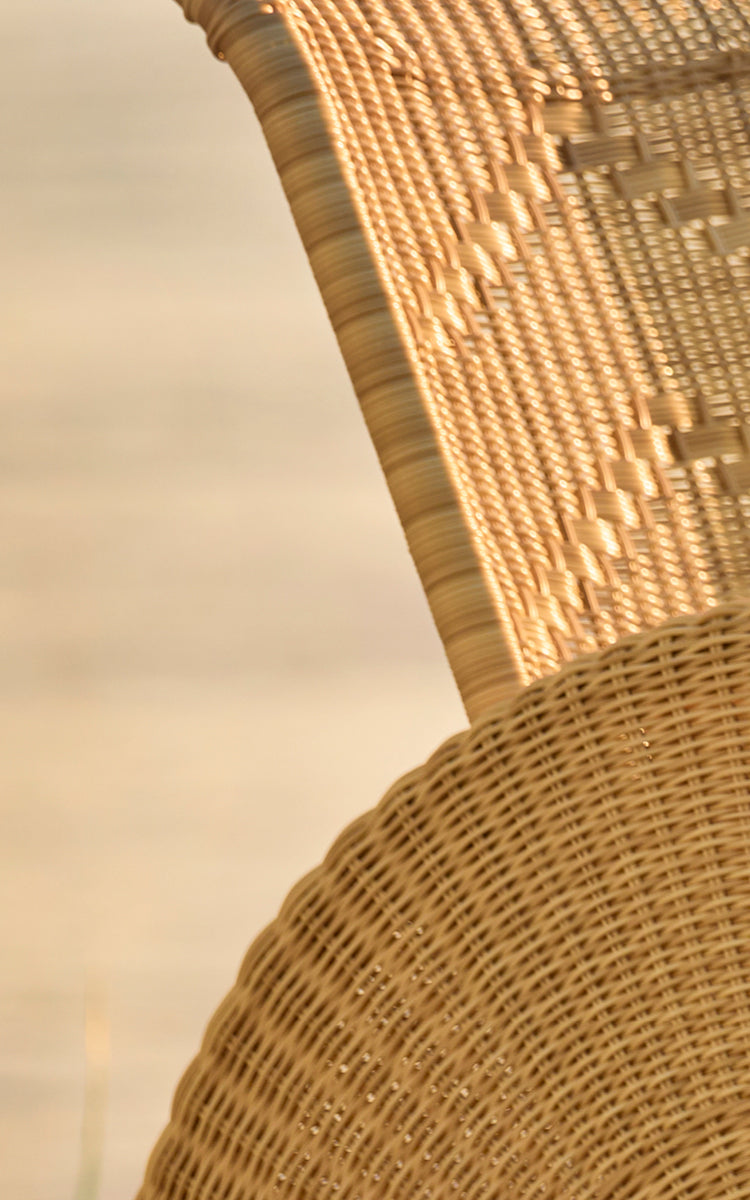 This is a close-up image of Paris Exterior Lounge Chair in natural core weave artfibre aluminium. Detail of the woven texture and frame construction.