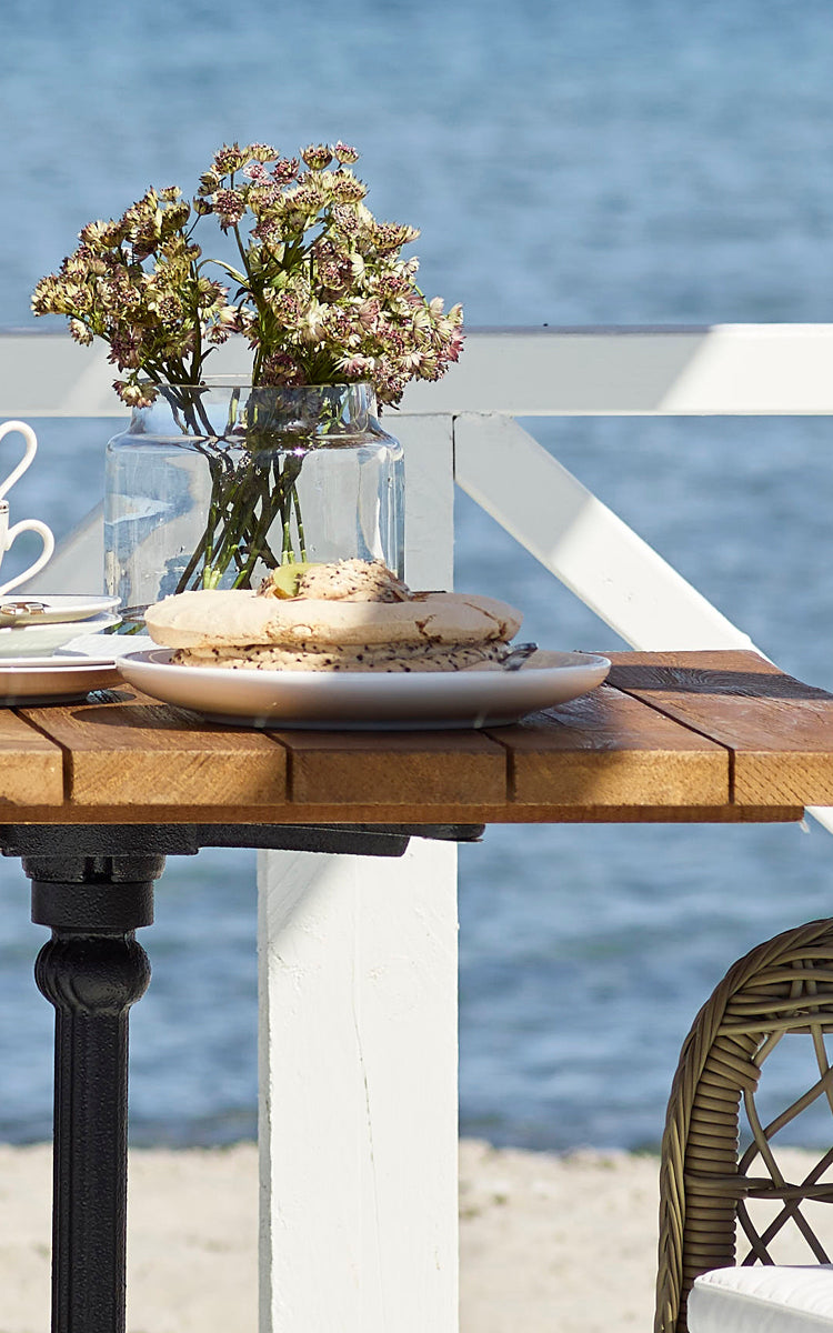 This is a close-up image of Lyon Bar Table | Teak 70x70 cm in cast iron.