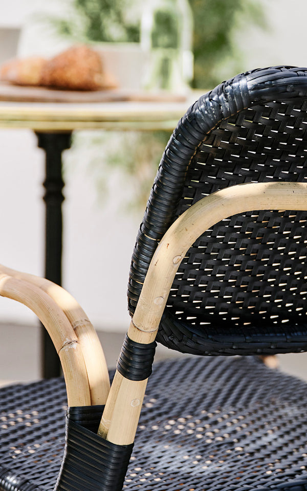 This is a close-up image of Bistro Dining Chair in skin on Rattan frame.