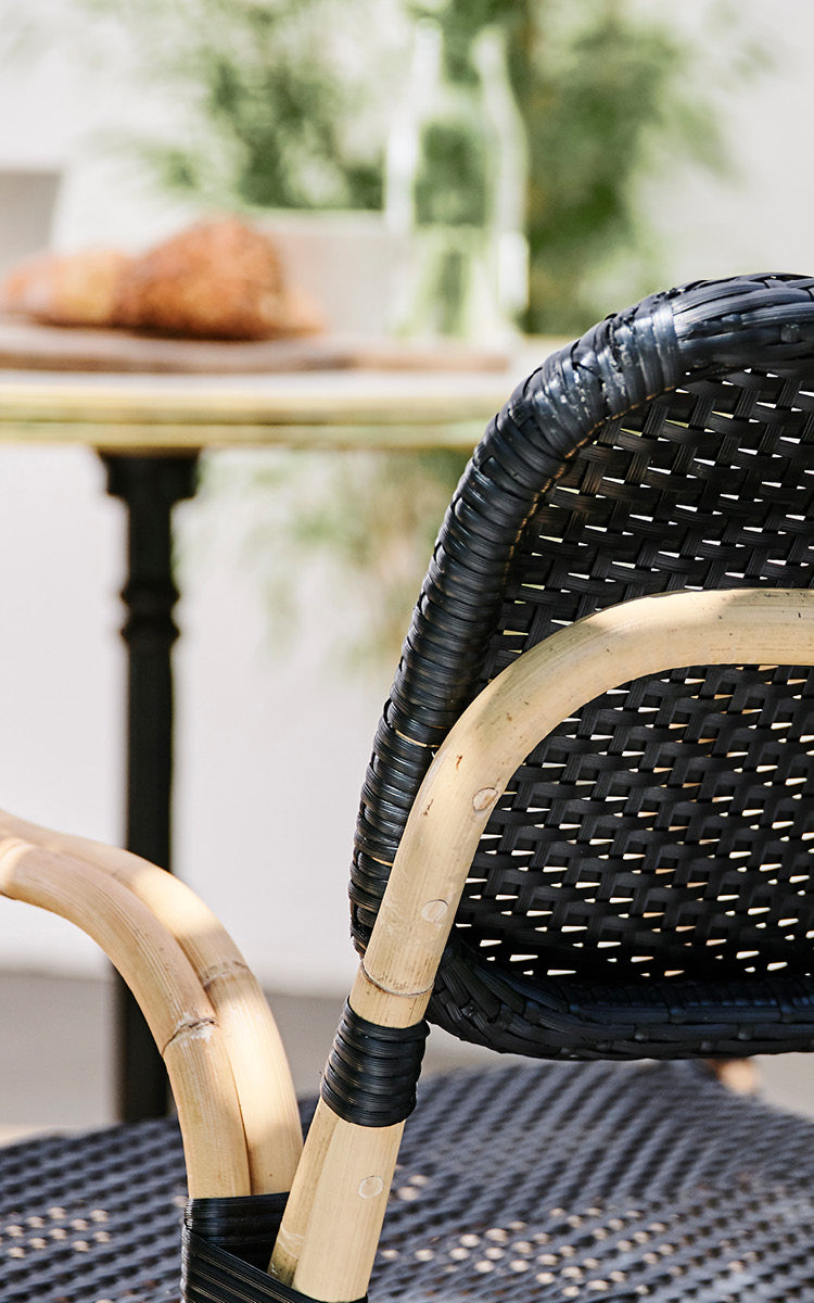 This is a close-up image of Bistro Bench in skin on Rattan frame.