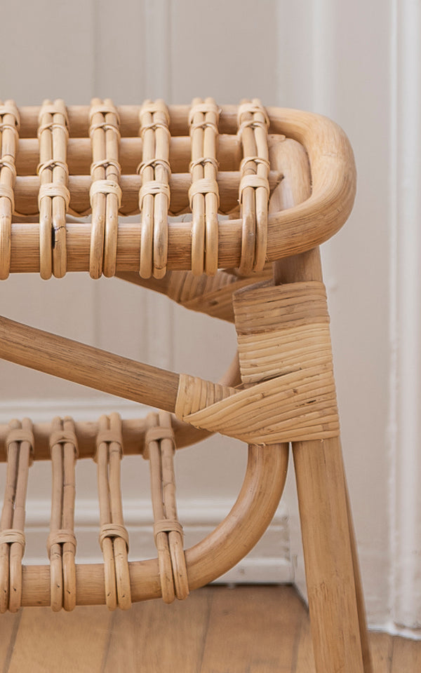 This is a close-up image of Machiya Bench in natural skin on rattan. Wrapped rattan joints and open loop seat construction detail.