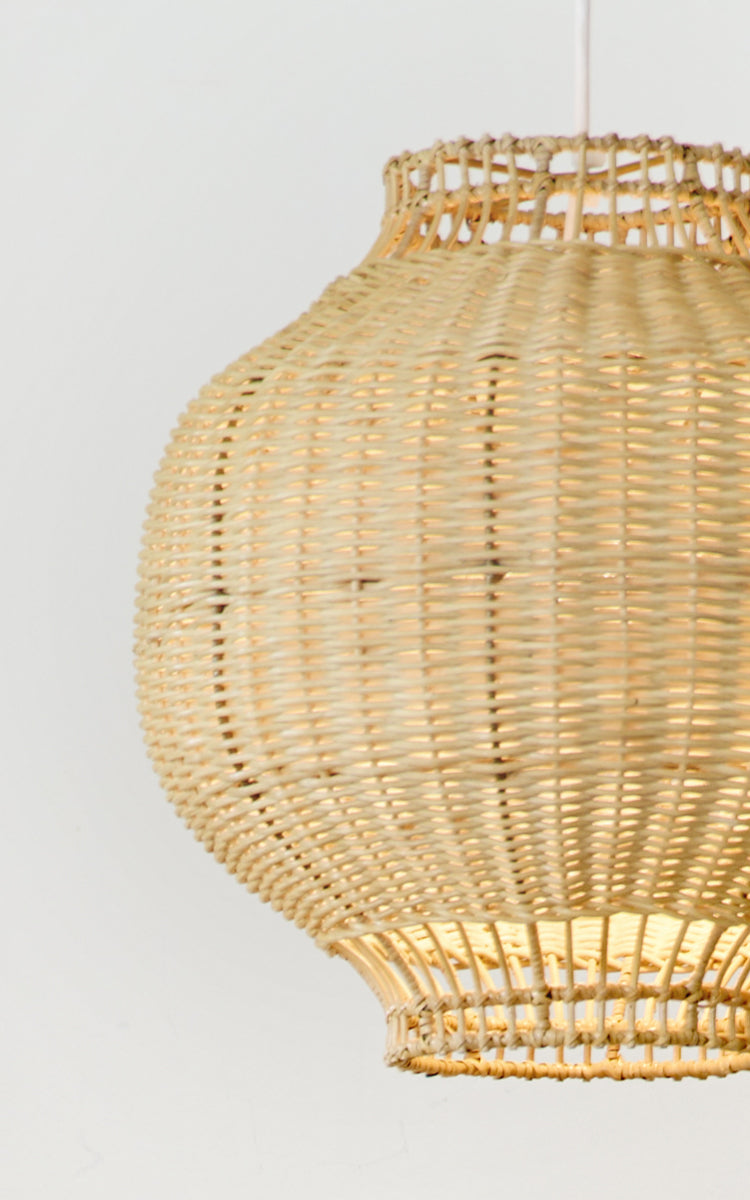 This is a close-up image of Tomos Lampshade in natural core weave rattan frame. The rounded bulbous shape with intricate weave is shown.