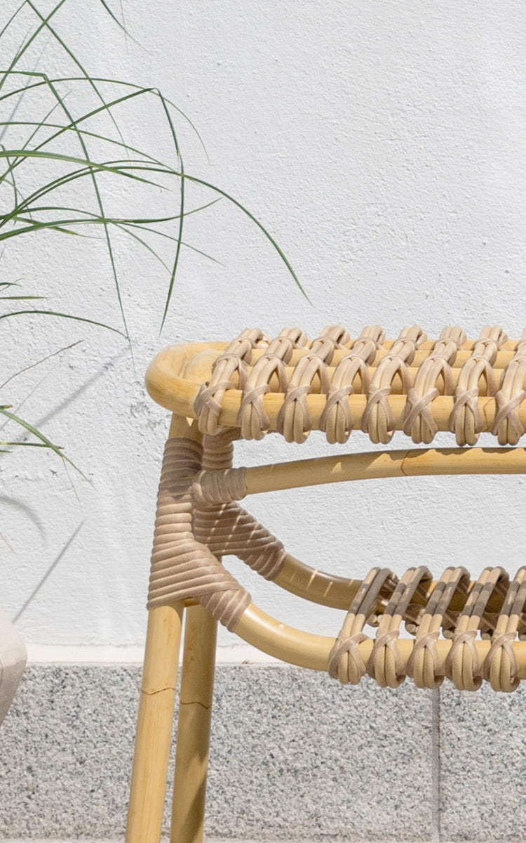 This is a close-up image of Machiya Exterior Bench in natural aluminium artfibre. Braided ArtFibre seat weave and wrapped frame joint detail.