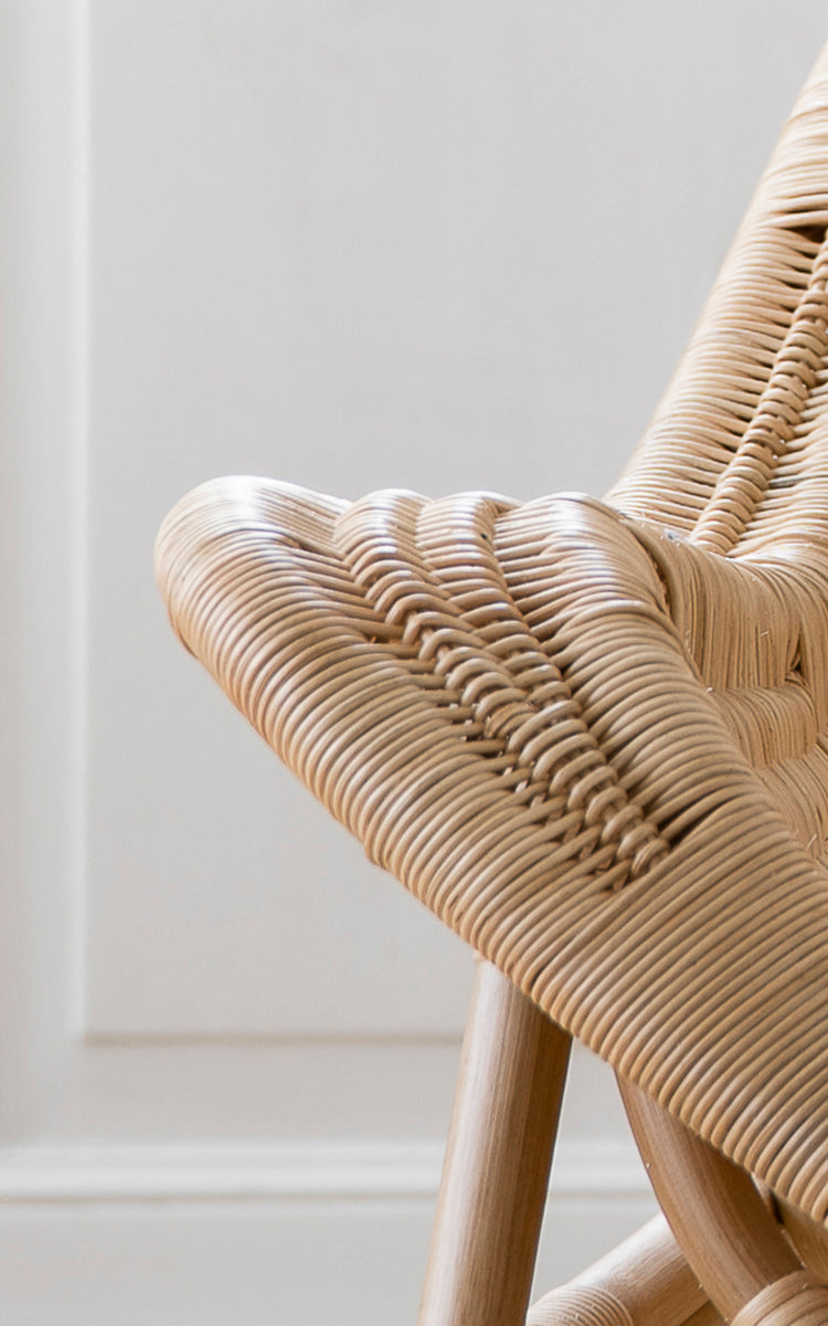 This is a close-up image of Pacifique Lounge Chair in natural core weave rattan frame. Detail of the woven texture and frame construction.