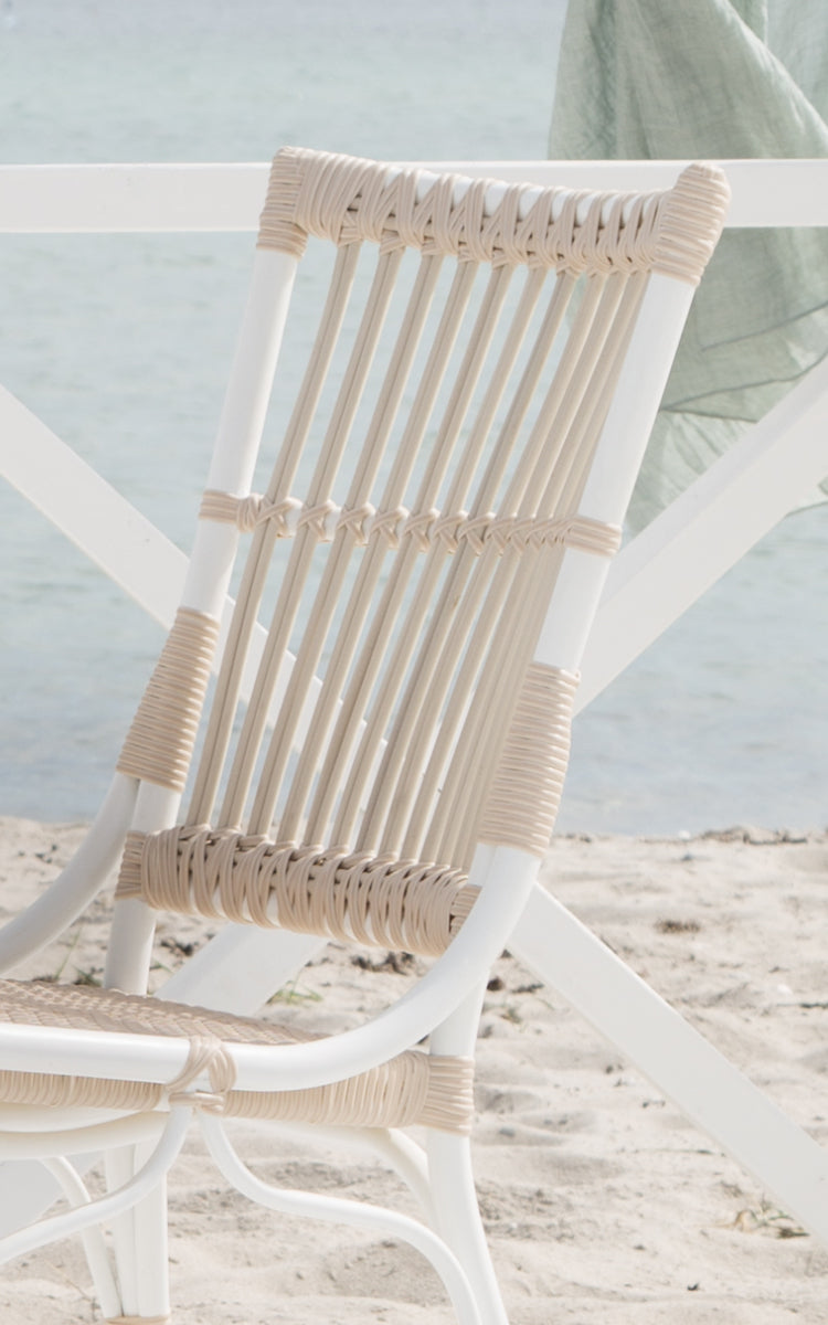 This is a close-up image of Piano Exterior Side Chair in dove white aluminium artfibre. Detail of the vertical ArtFibre rod backrest.
