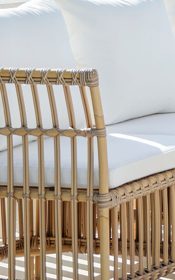 This is a close-up image of Meghan Exterior Dining Bench Corner Module in natural aluminium artfibre. Detail of the vertical rod back.