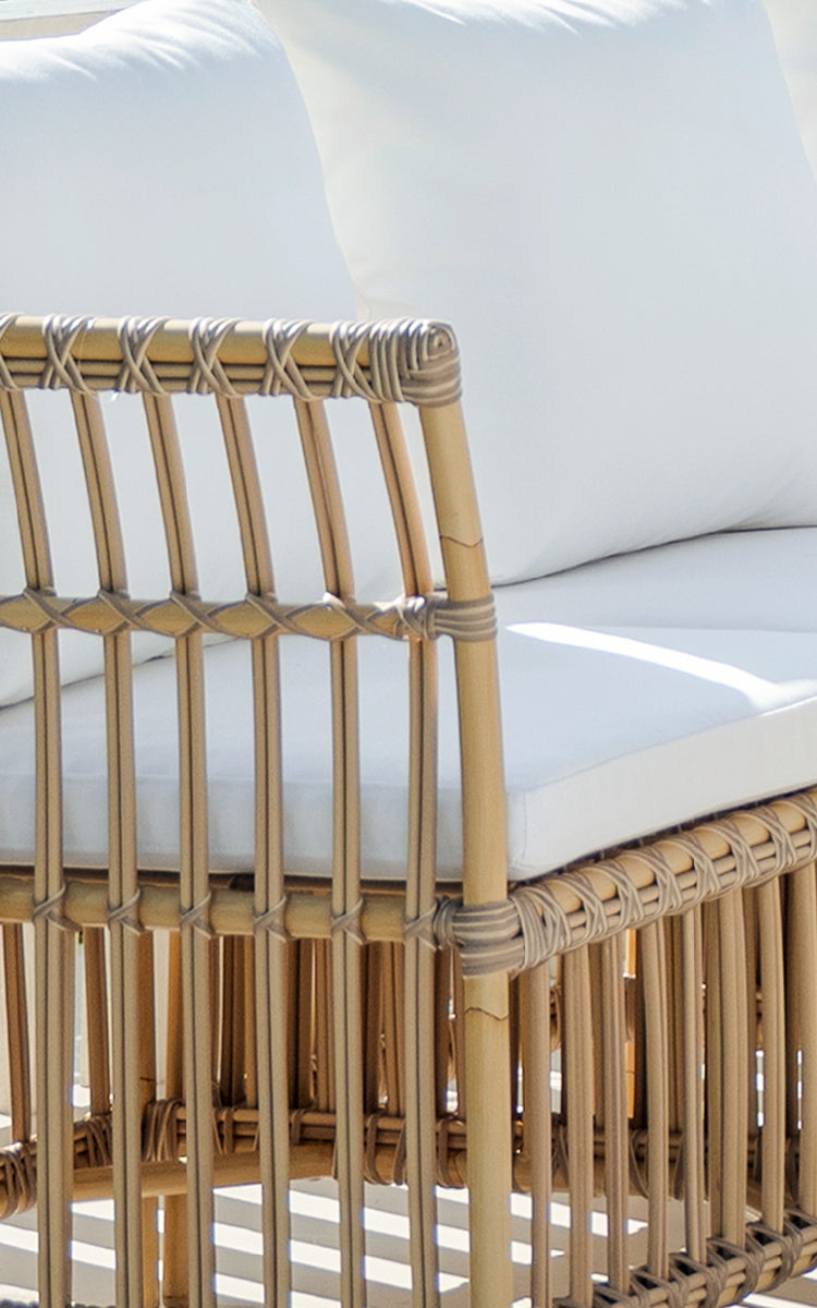 This is a close-up image of Meghan Exterior Dining Bench Corner Module in natural aluminium artfibre. Detail of the vertical rod back.