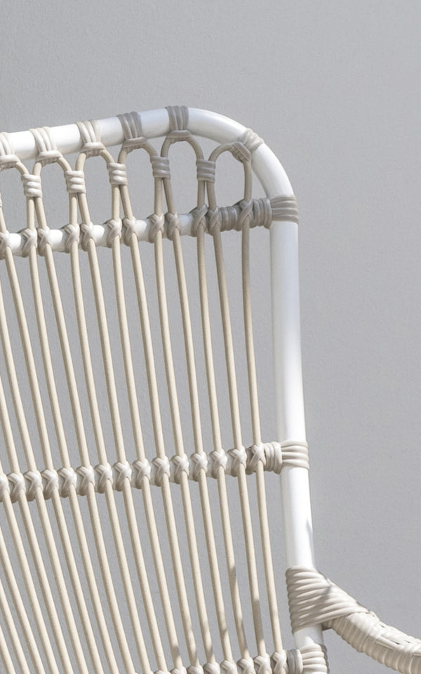 This is a close-up image of Monet Exterior Lounge Chair in dove white aluminium artfibre. Detail of the looped arch design.